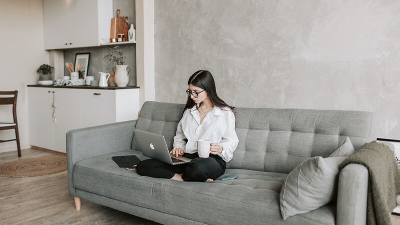 woman-sitting-on-sofa-while-working-at-home-4050295